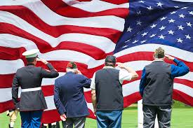 Veterans saluting american flag